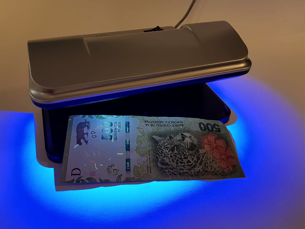 Cifra XB-115 revelando las marcas de seguridad fluorescentes de un billete de 500 pesos